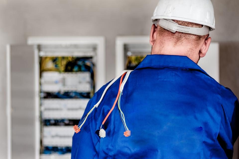 Electrician working at a commercial distribution panel
